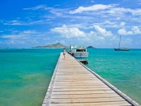 Young woman tourist on wooden jetty and beautiful Caribbean Sea, Carriacou Island, pkazmierczak